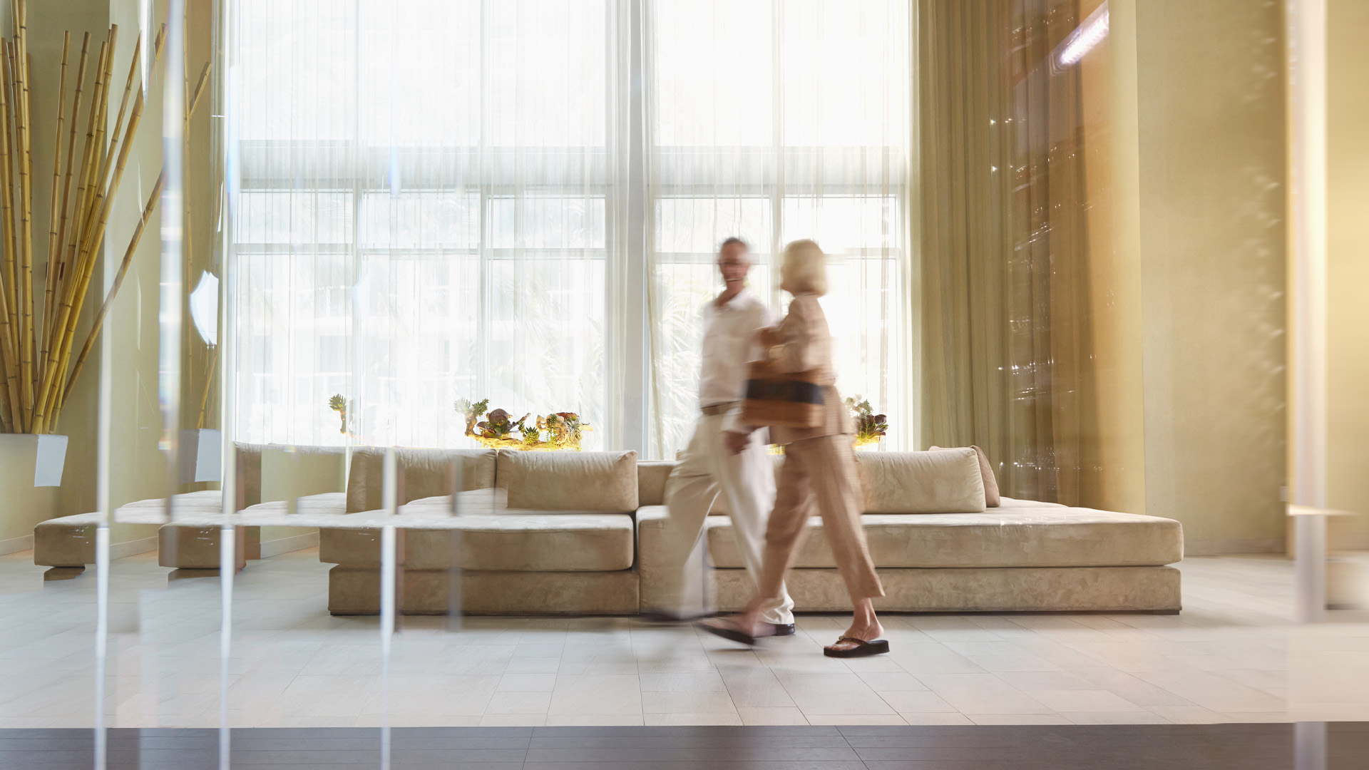 Man and woman walking through a hotel lobby